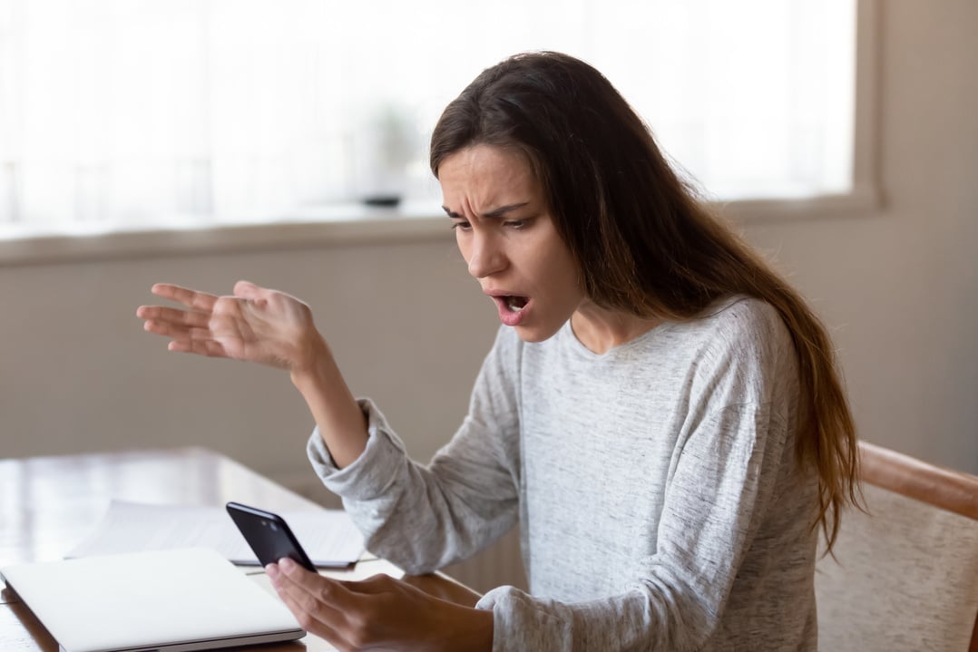 Angry Woman Looking at Mobile Phone